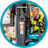 Worker in a hi-vis vest operating a forklift truck inside a warehouse, shown in a circular frame.